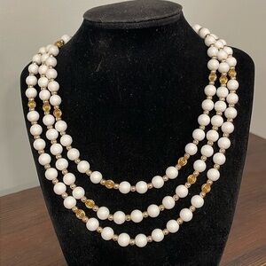 Vintage White and gold beaded triple strand with bow fold over gold tone clasp